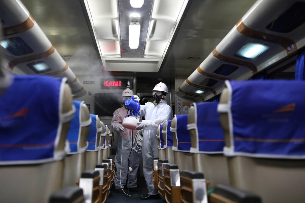(Trisnadi | The Associated Press) Health workers in protective gear sprays disinfectant inside a passenger train carriage in the wake of coronavirus outbreak at Pasar Turi train station in Surabaya, East Java, Indonesia, Sunday, March 15, 2020. For most people, the new coronavirus causes only mild or moderate symptoms. For some, it can cause more severe illness, especially in older adults and people with existing health problems.