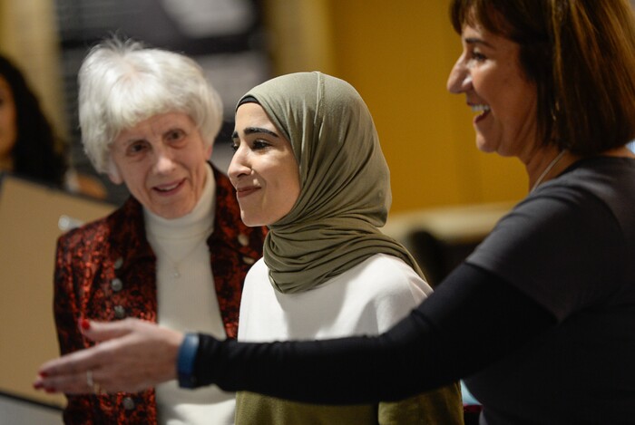 (Francisco Kjolseth  |  The Salt Lake Tribune)  Pamela Atkinson, left, joins Samira Harnish, at right, of Women of the World as they honor Sahar Najim who moved to Utah from Kuwait in 2014, during the 8th annual award ceremony at the Salt Lake County building in Salt Lake City on Saturday, Dec. 8, 2018. The event is a celebration of successes including educational, service, and employment milestones by refugee women.