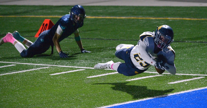 (Leah Hogsten | The Salt Lake Tribune) Summit Academy's Talmage Brown dives into the end zone. Summit Academy boys' football team leads Juan Diego High School 51-43 during their game, October 13, 2017 in Draper.
