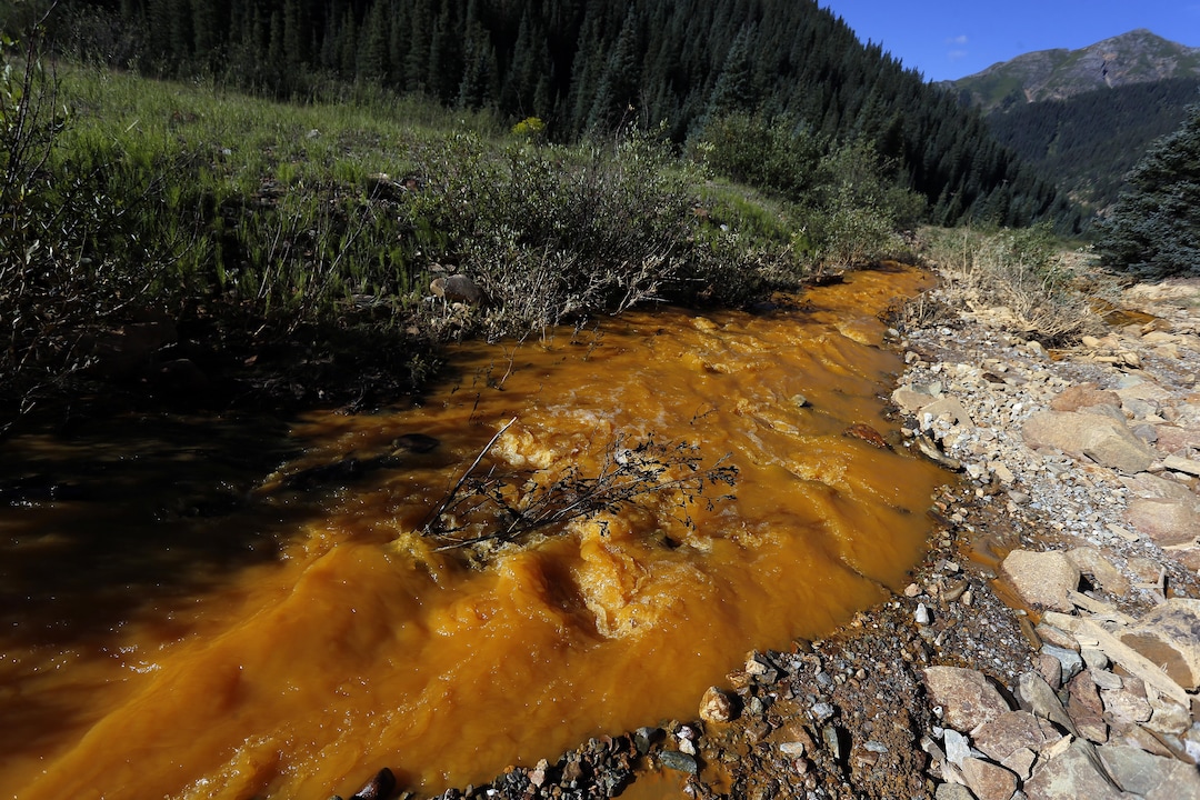 Water flows down Cement Creek just below the site of the blowout at the Gold King mine which triggered a major spill of toxic wastewater, outside Silverton, Colo., Thursday, Aug. 13, 2015. It will take years, if not decades, and many millions of dollars to clean up and manage the toxic wastewater from a this Colorado mine that unleashed a 100-mile-long torrent of heavy metals, affecting the livelihoods of residents in three states, according to some experts. (AP Photo/Brennan Linsley)