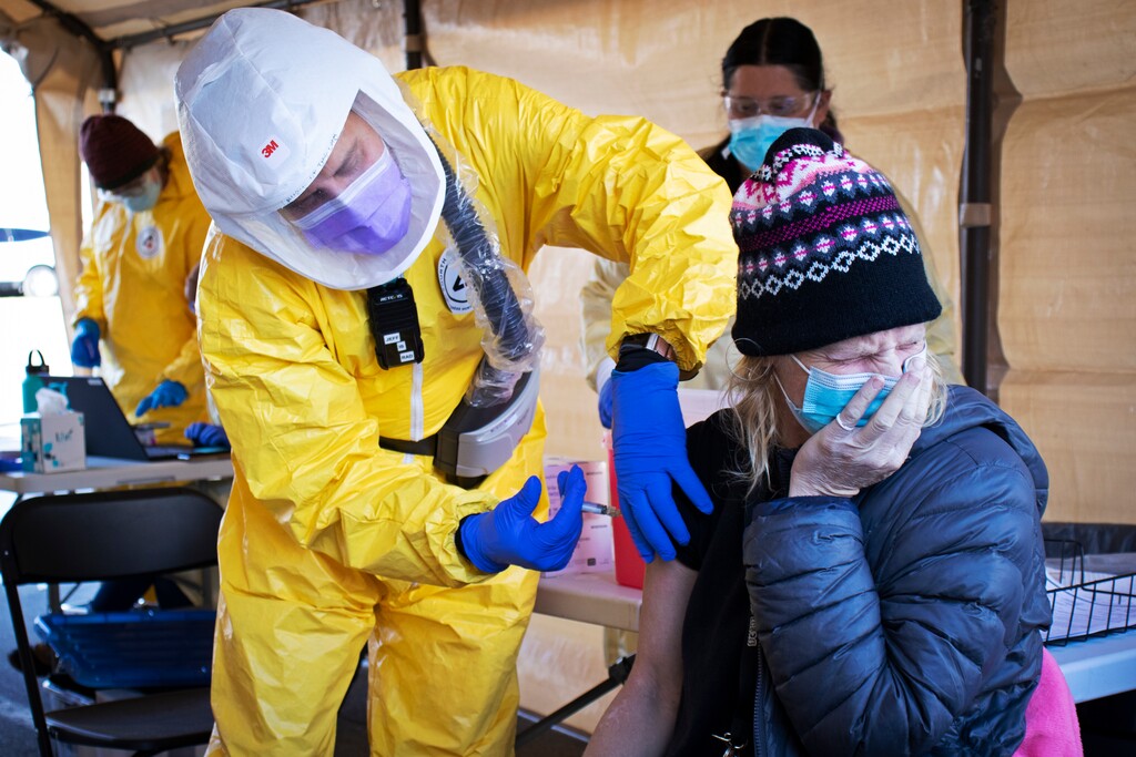 (Courtesy Fourth Street Clinic) A Fourth Street Clinic staffer vaccinates a woman in this undated photo.