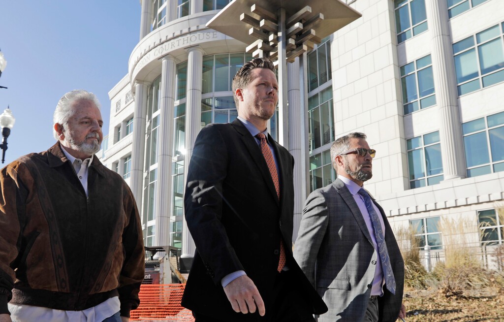 (Rick Bowmer | AP file photo) Paul Petersen, center, an Arizona elected official accused of running a multi-state adoption scheme, leaves court following an initial appearance on charges filed in the state Friday, Nov. 15, 2019, in Salt Lake City. Prosecutors in three states say Petersen brought pregnant women from the Marshall Islands to the United States and paid them to give up their babies for adoption. He's pleaded not guilty.