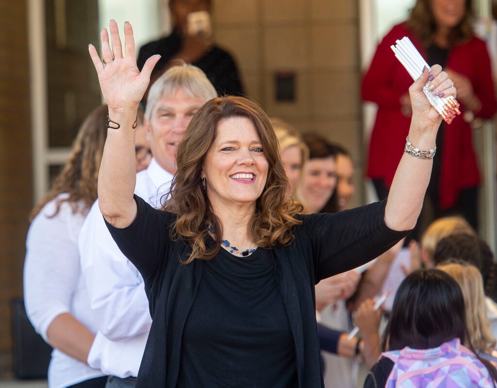 (Rick Egan  |  The Salt Lake Tribune)         Jeri Rigby, the new principal of Copperview Elementary School, cheers for her teachers and their students as they walk the red carpet on the first day of school, Monday, Aug. 19, 2019.