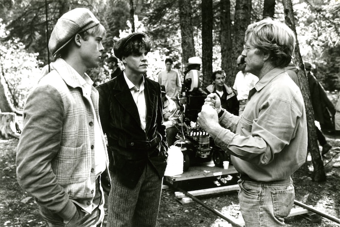 (Columbia Pictures) Director Robert Redford, right, discusses a scene with Brad Pitt and Craig Sheffer in the 1992 drama "A River Runs Through It."