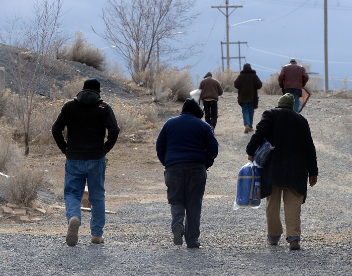 (Al Hartmann  |  The Salt Lake Tribune) 	
Homeless men walk back uphill to their camps in the rocks perched above Victory Road, on Thursday Feb. 15 2018.   Salt Lake City Police, Volunteers of America, Utah Highway Patrol, and social workers from Salt Lake City and the Veterans Administration had set up a mobile outreach center along Victory Road.