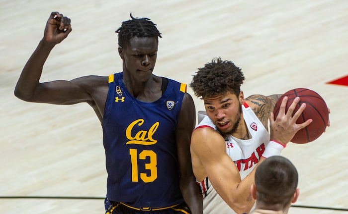 (Rick Egan | The Salt Lake Tribune) Utah Utes forward Timmy Allen (1) takes the ball to the basket as California Golden Bears forward Kuany Kuany (13) defends, in PAC12 Basketball action between the the Utah Utes and the California Golden Bears, on Wednesday, Jan. 16, 2021.
