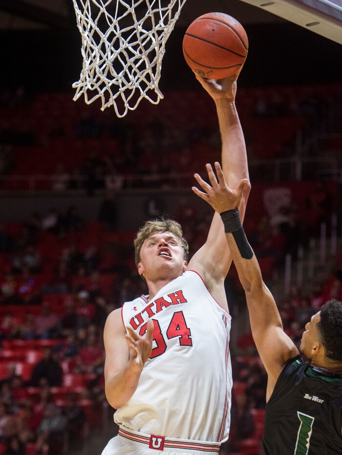 (Rick Egan  |  The Salt Lake Tribune)  Utah Utes forward Jayce Johnson (34) shoots over Hawaii Warriors guard Drew Buggs (1), in basketball action, Utah Utes vs Hawaii Warriors, at the Jon M. Huntsman Center, Saturday, December 2, 2017.