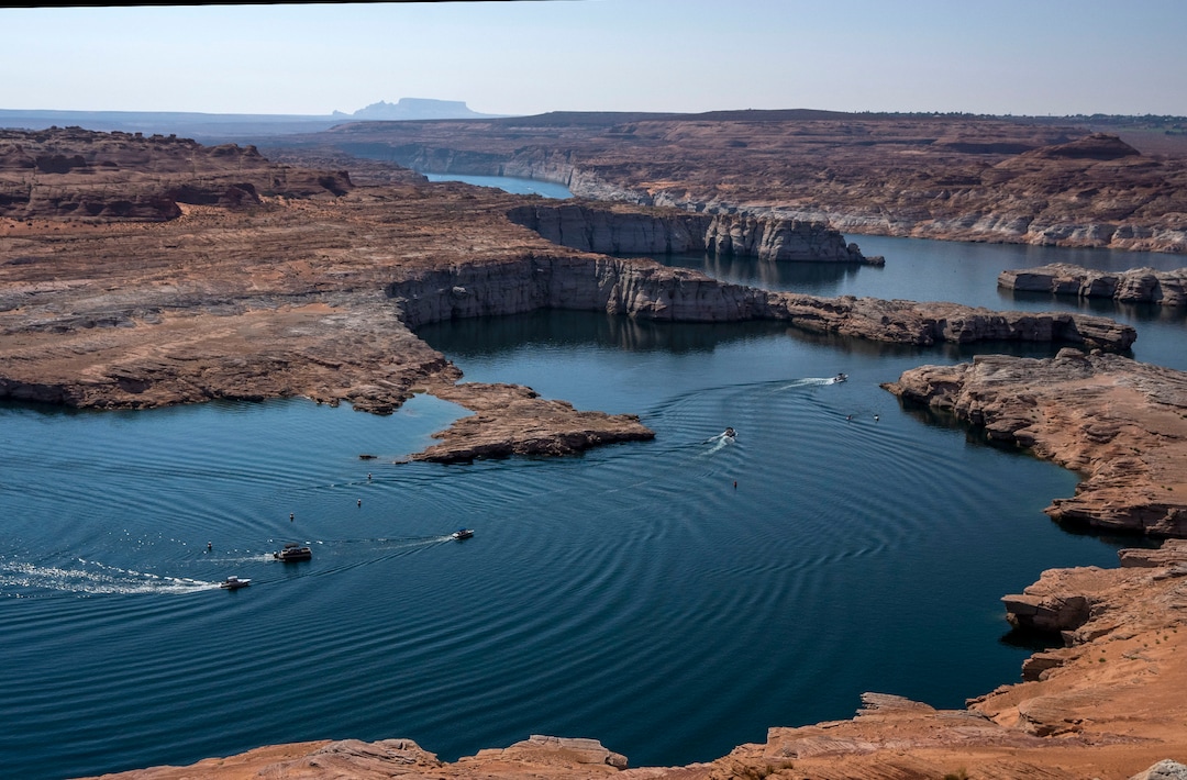 (Rick Egan | The Salt Lake Tribune)  Boats travel near the Glen Canyon Dam, on Tuesday, Aug. 3, 2021.