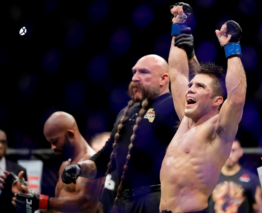 Henry Cejudo celebrates his win against Demetrious Johnson during their UFC flyweight title mixed martial arts bout at UFC 227 in Los Angeles, Saturday, Aug. 4, 2018. (AP Photo/Chris Carlson)