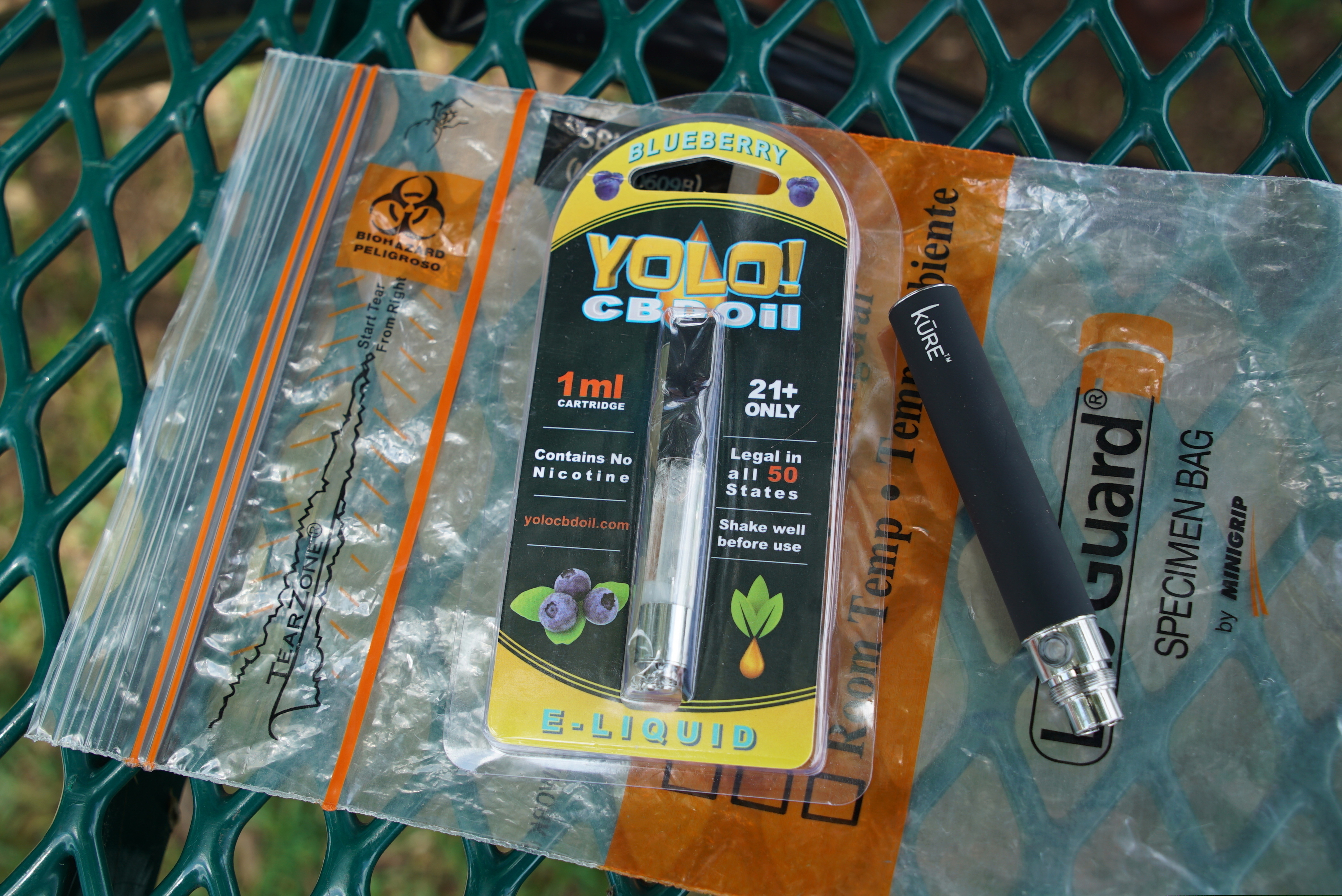 (Allen G. Breed | AP file photo) A Yolo! brand CBD oil vape cartridge sits alongside a vape pen on a biohazard bag on a table at a park in Ninety Six, S.C. More than 50 people around Salt Lake City had been poisoned by the time the outbreak ended early last year, most by a vape called Yolo!, the acronym for "you only live once."