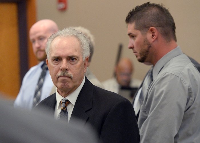(Al Hartmann | Tribune file photo) Former Daggett County Sheriff Jerry Jorgensen, front left, talks with lawyers and former jail commander Lt. Benjamin Lail, right, in Third District Court in Park City on July 17, 2017 before Judge Kent Holmberg on charges connected to the abuse of jail inmates at the Daggett County jail. A third person charged at far left is Deputy Joshua Cox.
