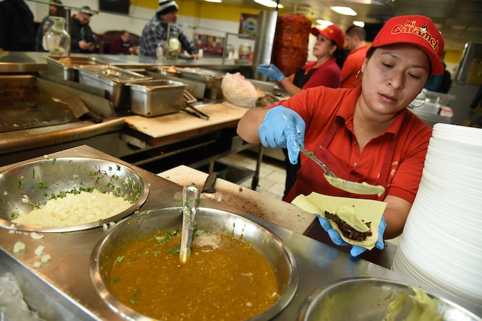 (Francisco Kjolseth  |  The Salt Lake Tribune)  Hilda Vargas assembles aside and tripa tacos for a customer at Tacos Mi Caramelo, a late-night taqueria that is open until 2 a.m. most nights and 24-hours a day on Friday and Saturday.