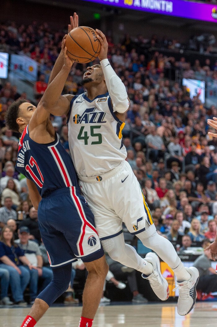 (Rick Egan  |  The Salt Lake Tribune)   Utah Jazz guard Donovan Mitchell (45) draws a foul as Washington Wizards guard Jerome Robinson (12) stops him from scoring, as he goes to the hoop, in NBA action between the Utah Jazz and the Washington Wizards, in Salt Lake City, Friday, February 28, 2020