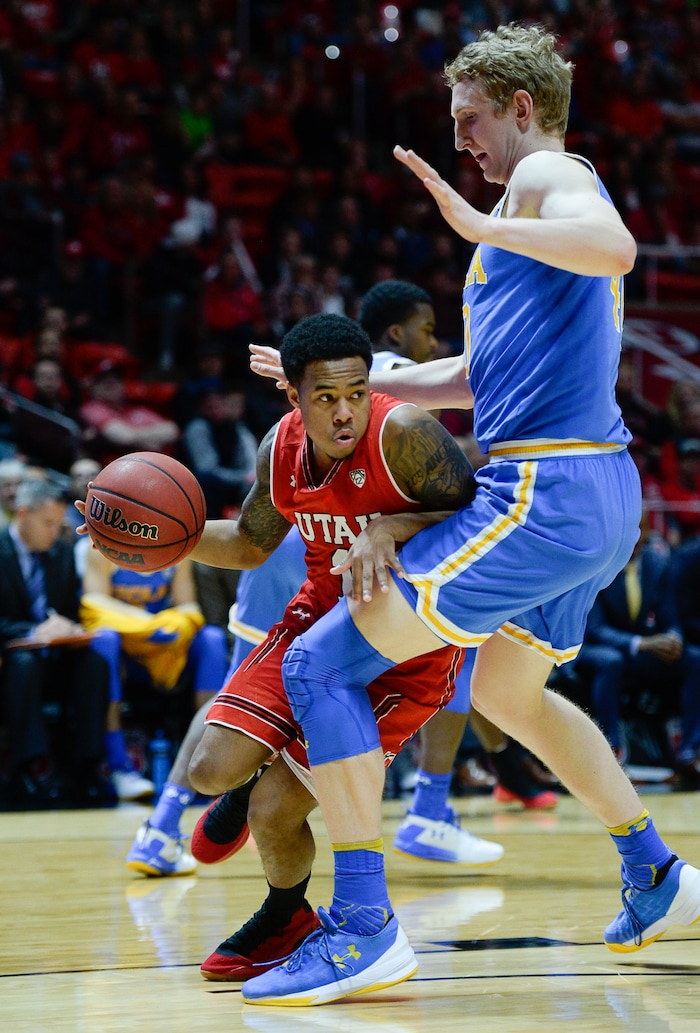 (Francisco Kjolseth  |  The Salt Lake Tribune)  Utah Utes guard Justin Bibbins (1) goes up against UCLA Bruins center Thomas Welsh (40) as the University of Utah hosts UCLA in NCAA basketball at the Huntsman Center in Salt Lake City, Thursday, Feb. 22, 2018.