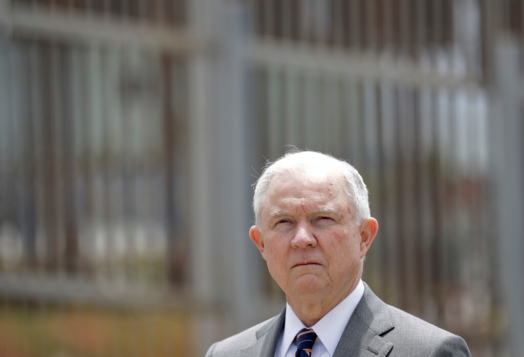 (Gregory Bull | The Associated Press) In this May 7, 2018, file photo, Attorney General Jeff Sessions listens during a news conference in San Diego near the border with Tijuana, Mexico. A judge allowed a lawsuit challenging U.S. immigration authorities for separating parents from their children to go forward on Wednesday, June 6, but said he would decide later whether or not to order a nationwide halt. Splitting families has emerged as a high-profile and highly controversial practice since Sessions announced a “zero tolerance” policy at the border in early May. Any adult who enters the country illegally is criminally prosecuted, even if it means separating parents from children.
