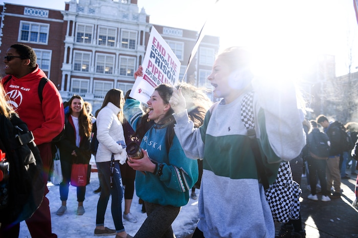 East High School sophomores Waverly Reeves, center left, and Annika Shassetz, foreground right, march with teachers during a Denver Public Schools teachers strike on Monday, Feb. 11, 2019, in Denver. Some 2,100 educators did not report for work on Monday during Day 1 of the first DPS strike in 25 years. (AAron Ontiveroz/The Denver Post via AP)