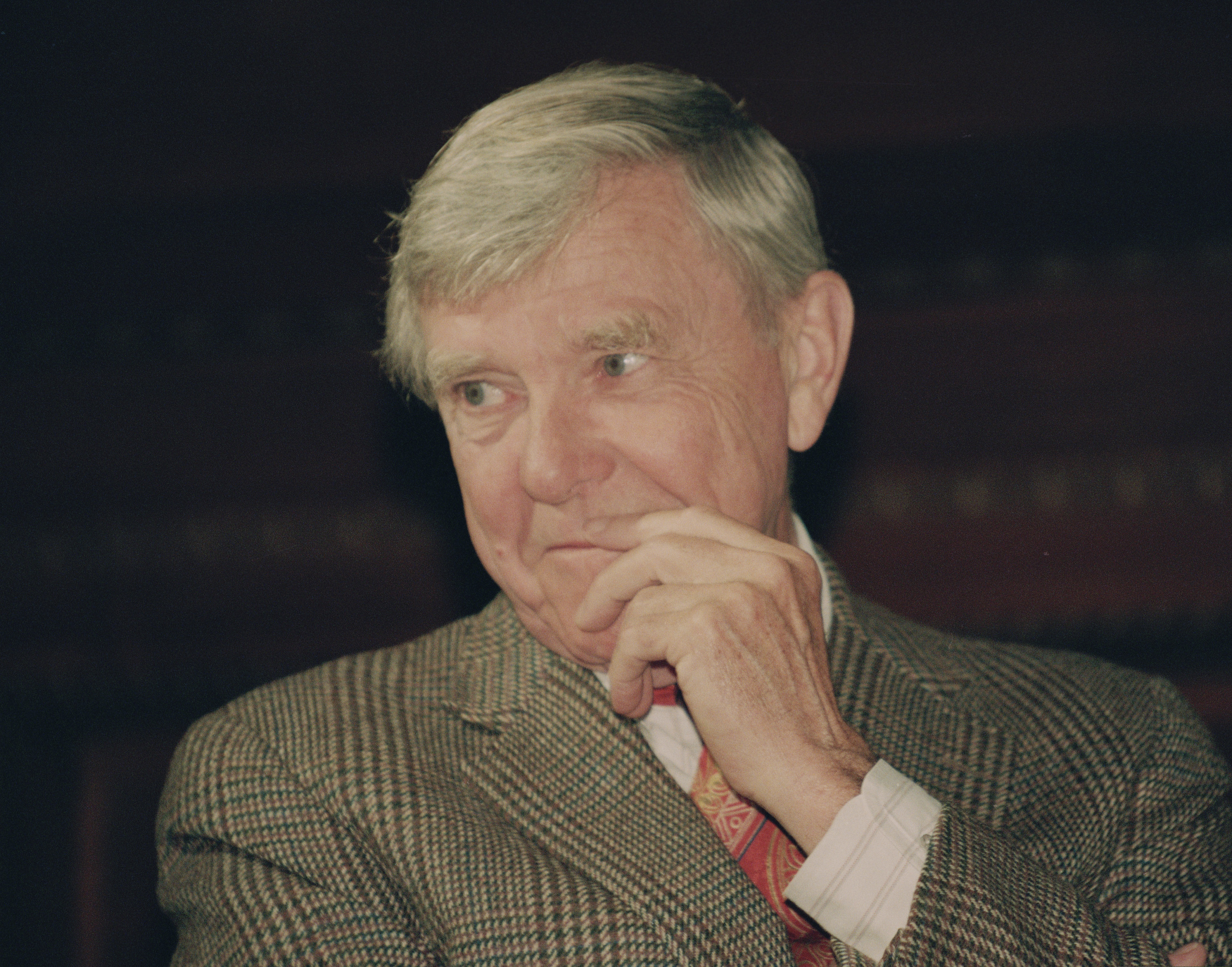 FILE - In this Tuesday, Feb. 23, 1993 file photo, writer Russell Baker, ponders a reporter's question during a New York news conference where he was presented as the successor to host Alistair Cooke for the PBS series "Masterpiece Theatre." Pulitzer Prize-winning author and humorist Baker has died at age 93. Allen Baker told The Associated Press that his father died on Monday, Jan. 21, 2019, from complications after a fall. (AP Photo/Alex Brandon, File)