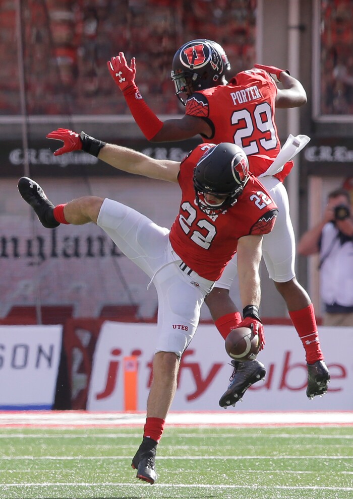 Utah's Chase Hansen (22) celebrates with teammate Reginald Porter (29) after his interception against Washington in the first half of an NCAA college football game, Saturday, Oct. 29, 2016, in Salt Lake City. (AP Photo/Rick Bowmer)