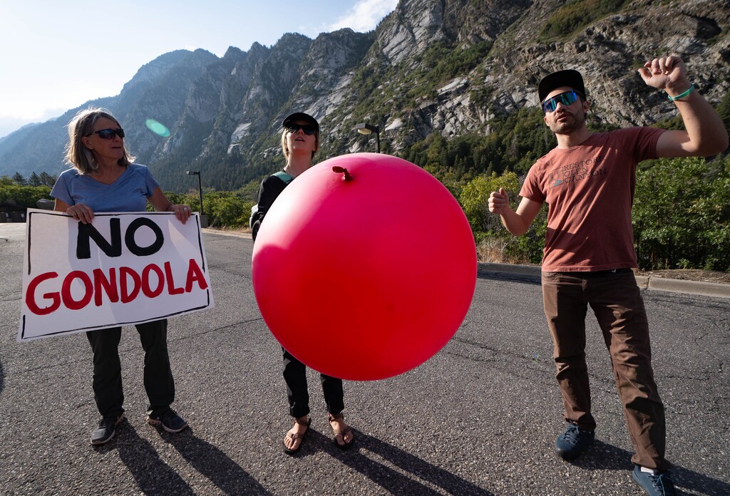 (Francisco Kjolseth | The Salt Lake Tribune) Community member Jennifer Weiler, Dani Poirier with Wasatch Back County Alliance and Jack Stauss, from left, fly large balloons over the mouth of Little Cottonwood Canyon on Saturday, Aug. 21, 2021, to demonstrate the height of gondola towers the Utah Department of Transportation is proposing be built to carry people up to Alta and Snowbird ski resorts.