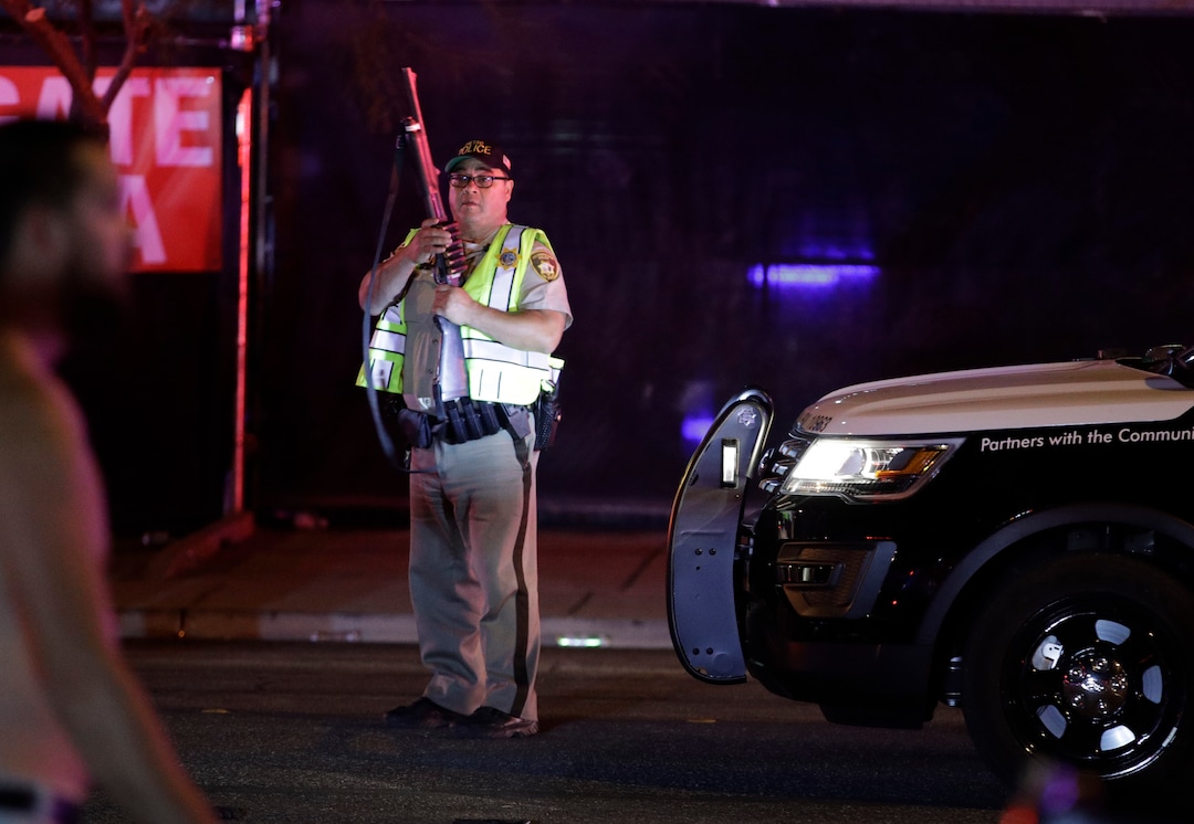 A police officer stands at the scene of a shooting along the Las Vegas Strip, Monday, Oct. 2, 2017, in Las Vegas. Multiple victims were being transported to hospitals after a shooting late Sunday at a music festival on the Las Vegas Strip. (AP Photo/John Locher)