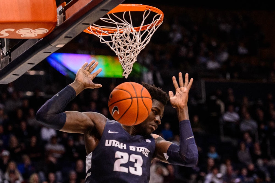 (Trent Nelson | The Salt Lake Tribune)  Utah State Aggies center Neemias Queta (23) dunks as BYU hosts Utah State, NCAA basketball in Provo on Wednesday Dec. 5, 2018.