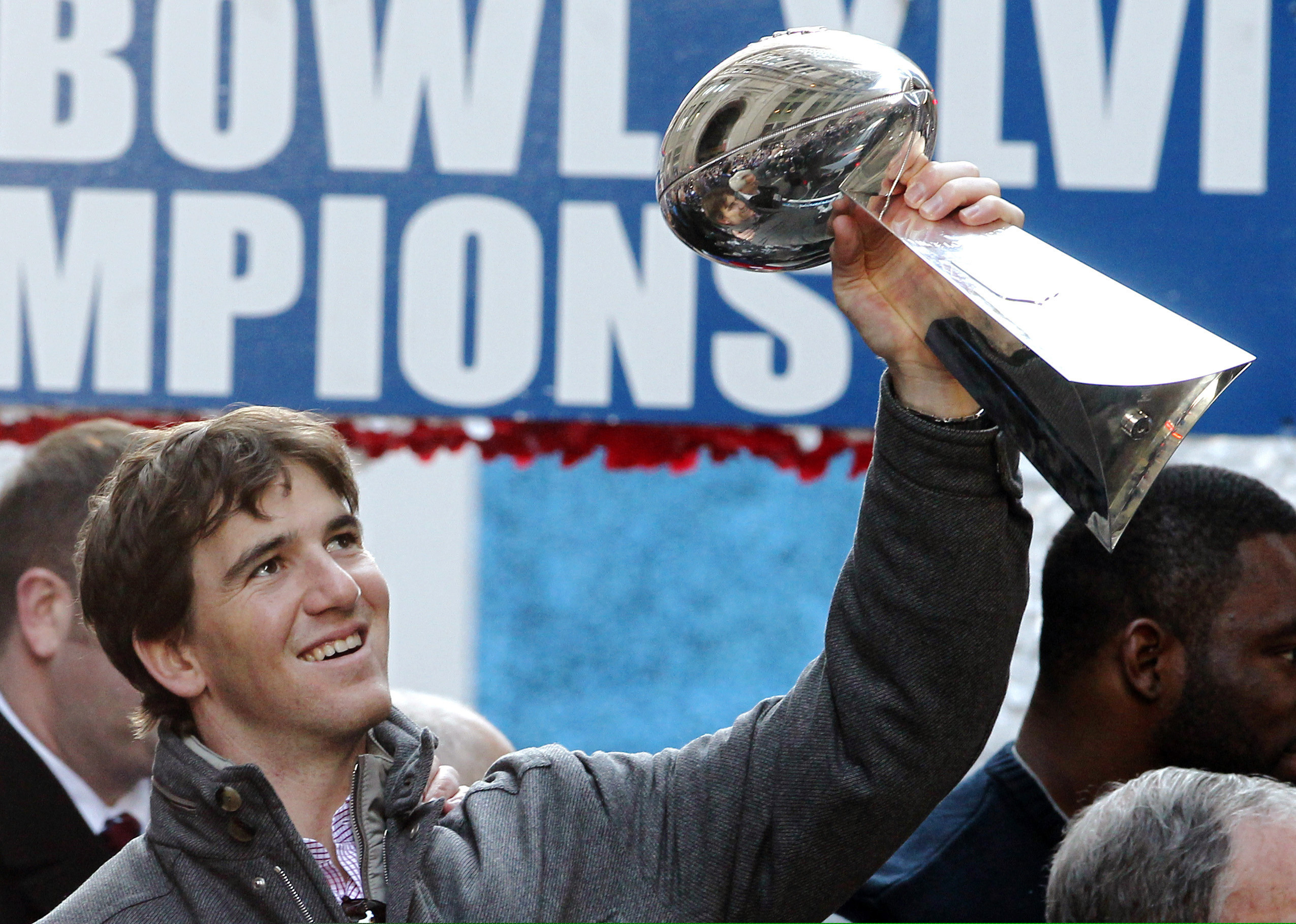 (Julio Cortez | AP File Photo) In this Feb. 7, 2012 photo New York Giants quarterback Eli Manning holds up the Vince Lombardi Trophy during the team's NFL football Super Bowl parade in New York. Manning, who led the Giants to two Super Bowls in a 16-year career that saw him set almost every team passing record, has retired. The Giants said Wednesday, Jan. 22, 2020 that Manning would formally announce his retirement on Friday.
