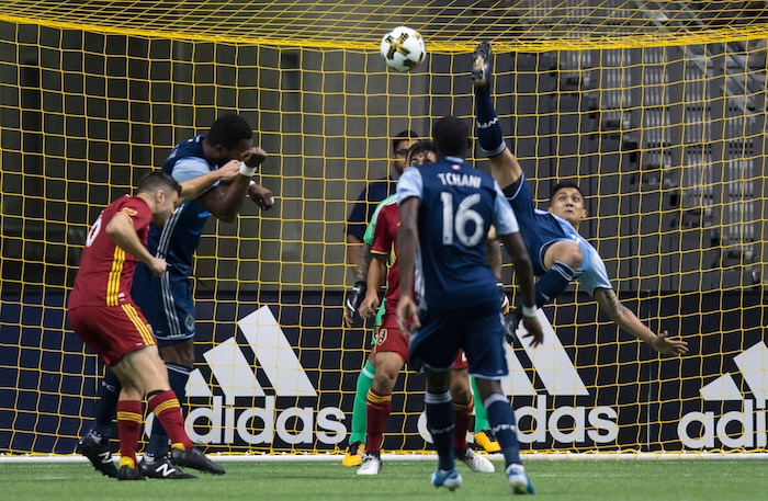 Vancouver Whitecaps' Fredy Montero, right, tries to get his foot on the ball off a corner kick in front of Real Salt Lake goalkeeper Nick Rimando during the first half of an MLS soccer match Saturday, Sept. 9, 2017, in Vancouver, British Columbia. (Darryl Dyck/The Canadian Press via AP)