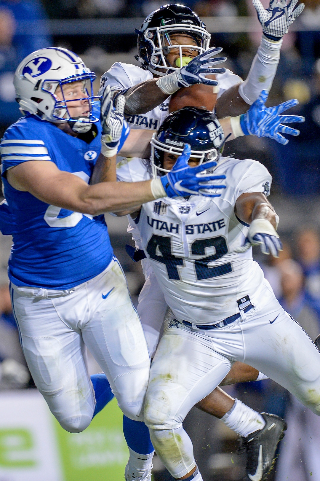 Leah Hogsten  |  The Salt Lake Tribune A pass intended for Brigham Young Cougars tight end Matt Bushman (89) is broken up by Utah State Aggies linebacker Suli Tamaivena (42) and Utah State Aggies safety Aaron Wade (4) as BYU hosts Utah State University at Lavell Edwards Stadium in Provo, Friday, Oct. 5, 2018.