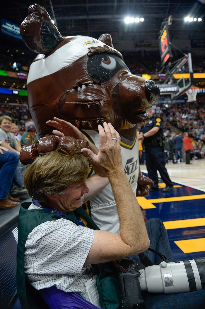 (Francisco Kjolseth  |  The Salt Lake Tribune)  Photographer Steve Griffin gets mobbed by an inflatable bear during a time out in the in the first half of the preseason NBA Jazz vs Raptors game at Vivint Smart Home Arena Tuesday, Oct. 2, 2018, in Salt Lake City.
