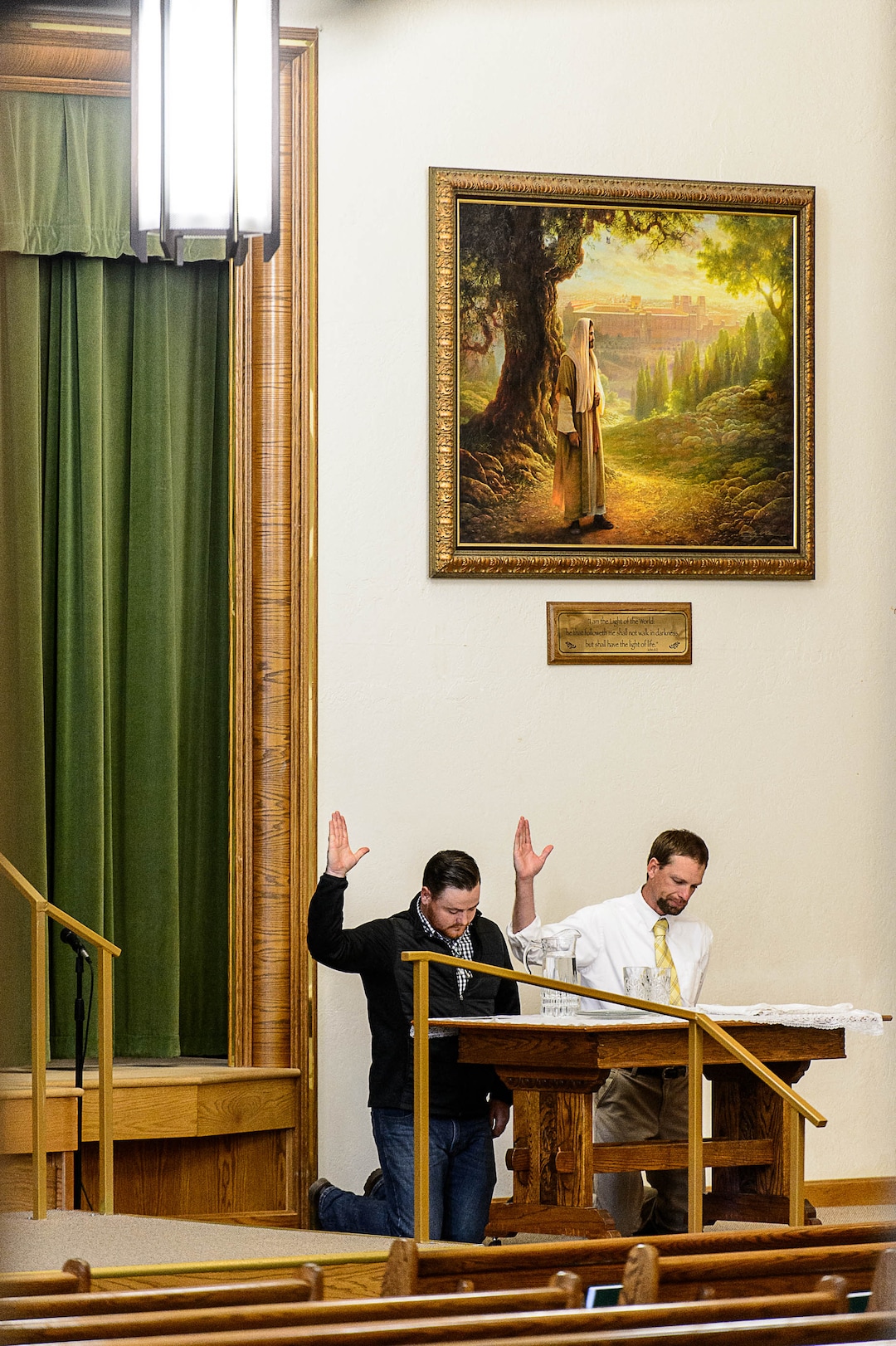(Trent Nelson | The Salt Lake Tribune)  James Jensen and Paul Jessop bless water during a Sacrament Meeting of the Pinesdale Second Ward, in Pinesdale, Mont.