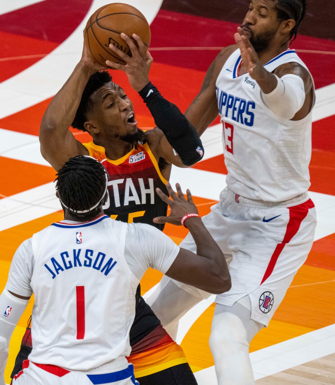 (Rick Egan | The Salt Lake Tribune) Utah Jazz guard Donovan Mitchell (45) is double-teamed by LA Clippers guard Reggie Jackson (1) and LA Clippers guard Paul George (13), in second round playoff action in game 2 between the Utah Jazz and the LA Clippers, at Vivint Arena, on Thursday, June 10, 2021.
