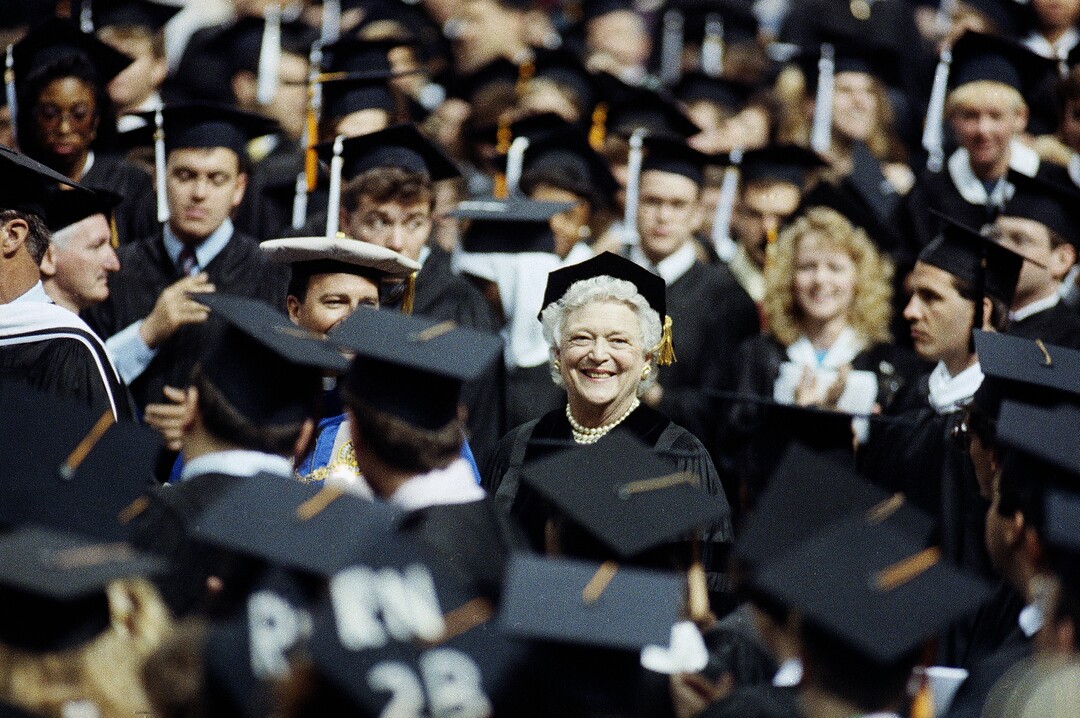 FILE - In this May 19, 1990, file photo, first lady Barbara Bush, center, smiles while being greeted by graduates at St. Louis University in St. Louis, Mo. A family spokesman said Tuesday, April 17, 2018, that former first lady Barbara Bush has died at the age of 92. (AP Photo/James A. Finley, File)