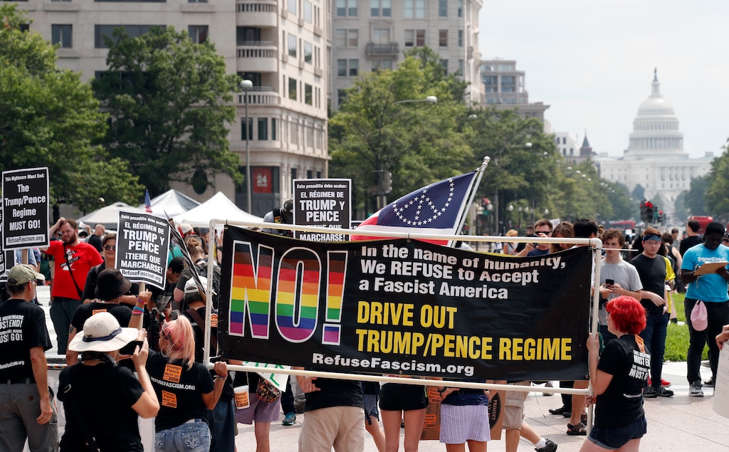 (AP Photo/Alex Brandon) Groups protest in Freedom Plaza with the U.S. Capitol in the background, on the one-year anniversary of Charlottesville's "Unite the Right" rally, Sunday, Aug. 12, 2018, in Washington.