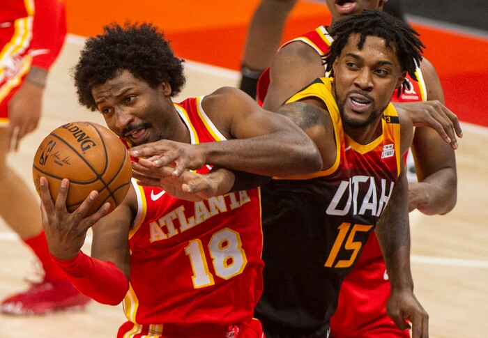 (Rick Egan | The Salt Lake Tribune). Utah center Derrick Favors (15) goes for a rebound along with Atlanta Hawks forward Solomon Hill (18) in NBA action between the Utah Jazz and the Atlanta Hawks at Vivint Arena, on Friday, Jan. 15, 2021.,