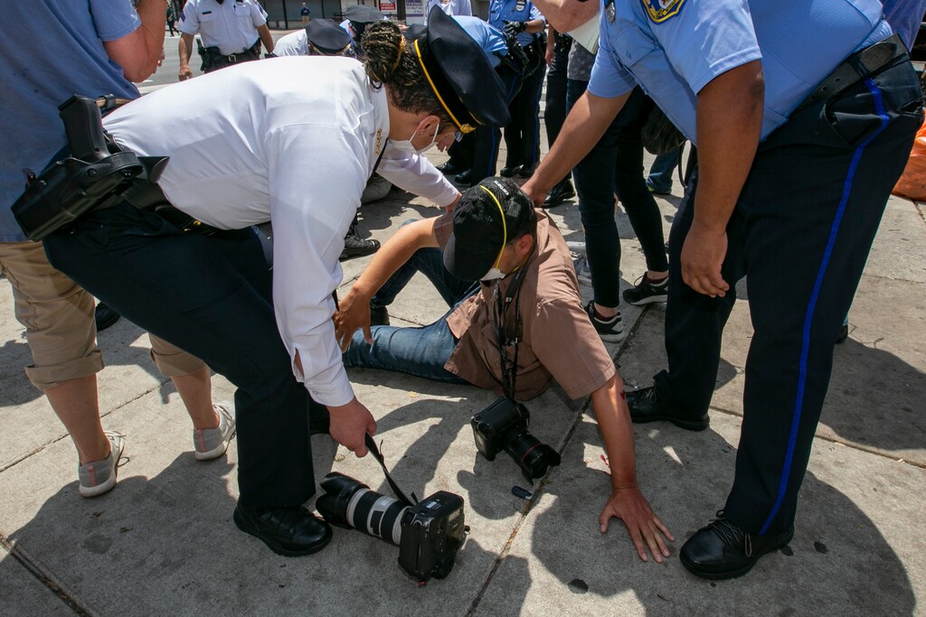 (Alejandro A. Alvarez/The Philadelphia Inquirer via AP)
Police Commissioner Danielle Outlaw, left, and other officers attend to Associated Press photographer Matt Rourke after he was assaulted while touring the business district with Philadelphia Mayor Jim Kenney and police officers at N. Broad Street and Erie Avenue in Philadelphia on Thursday, June 4, 2020.