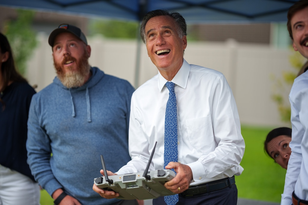 (Trent Nelson  |  The Salt Lake Tribune) Utah Sen. Mitt Romney flies a Teal 2 drone during a tour of Teal Drones in Salt Lake City on Tuesday, Aug. 22, 2023. At left is Evan Paul.