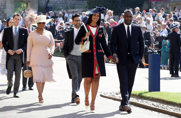 British actor Idris Elba, right, arrives with his fiancee Sabrina Dhowre for the wedding ceremony of Prince Harry and Meghan Markle at St. George's Chapel in Windsor Castle in Windsor, near London, England, Saturday, May 19, 2018. (Chris Radburn/pool photo via AP)
