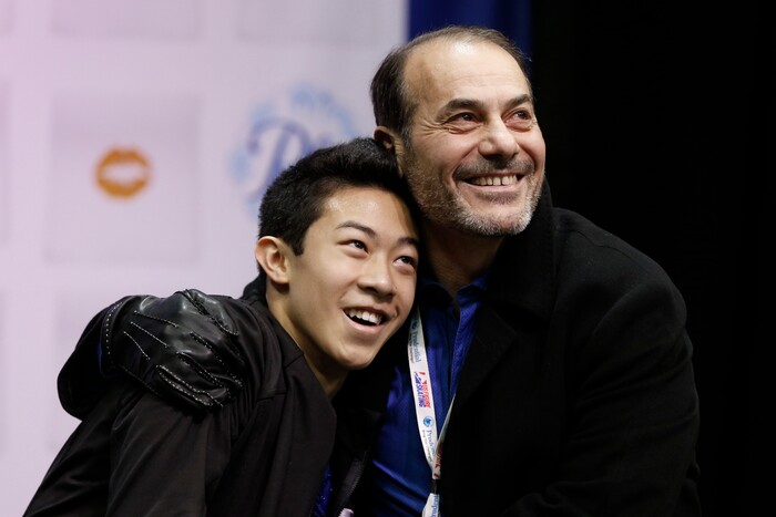 Nathan Chen, left, gets a hug from coach Rafael Arutyunian after he completed the men's free skate program of the U.S. Figure Skating Championships, Sunday, Jan. 24, 2016, in St. Paul, Minn. Chen picked up the bronze medal in the men's program. (AP Photo/Jim Mone)
