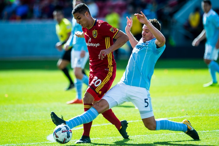 (Chris Detrick  |  The Salt Lake Tribune)  Real Salt Lake midfielder Luis Silva (20) and Sporting Kansas City defender Matt Besler (5) go for the ball during the game at Rio Tinto Stadium Sunday, October 22, 2017.  
