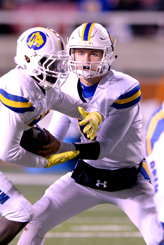 (Leah Hogsten  |  The Salt Lake Tribune)  Orem's quarterback Cooper Legas hands off to Raphael Cooper.  Orem High School defeated Sky View High School 28-12 during their class 4A state semifinal game at Rice-Eccles Stadium, Friday, Nov. 10, 2017.