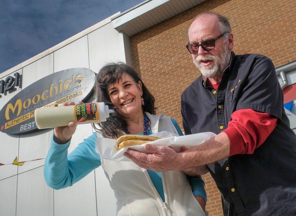 (Leah Hogsten | The Salt Lake Tribune) Moochie's is a top contender in The Salt Lake Tribune's Best Philly Cheesesteak poll. "This has been my lifelong dream," said Moochie's co-owner and Philidelphia native Joanna Rendi with partner Don MacDonald in front of their storefront at 2121 S. State St., Feb. 11, 2021. Rendi also created the eatery's Jumpin' Jalapeno Sauce.