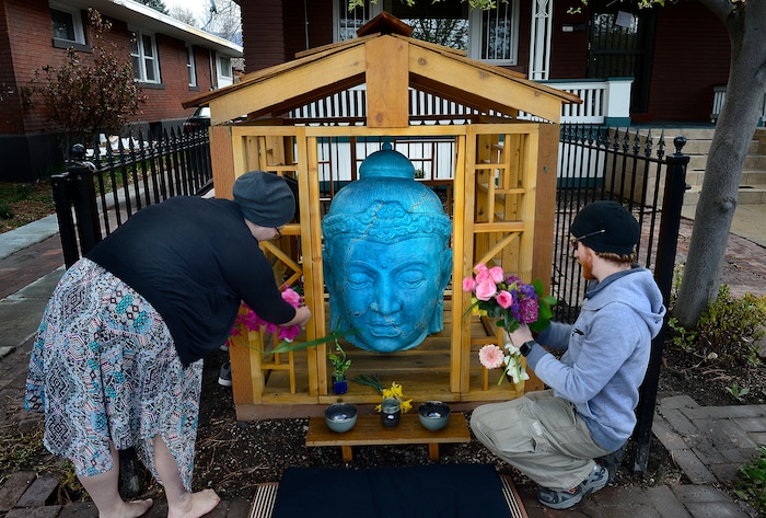 (Scott Sommerdorf | The Salt Lake Tribune)
Flowers and other offerings are placed around the Buddha on 9th, the Sugar House landmark and Buddhist Shrine, prior to the rededication ceremony and celebration, Sunday, April 8, 2018.
