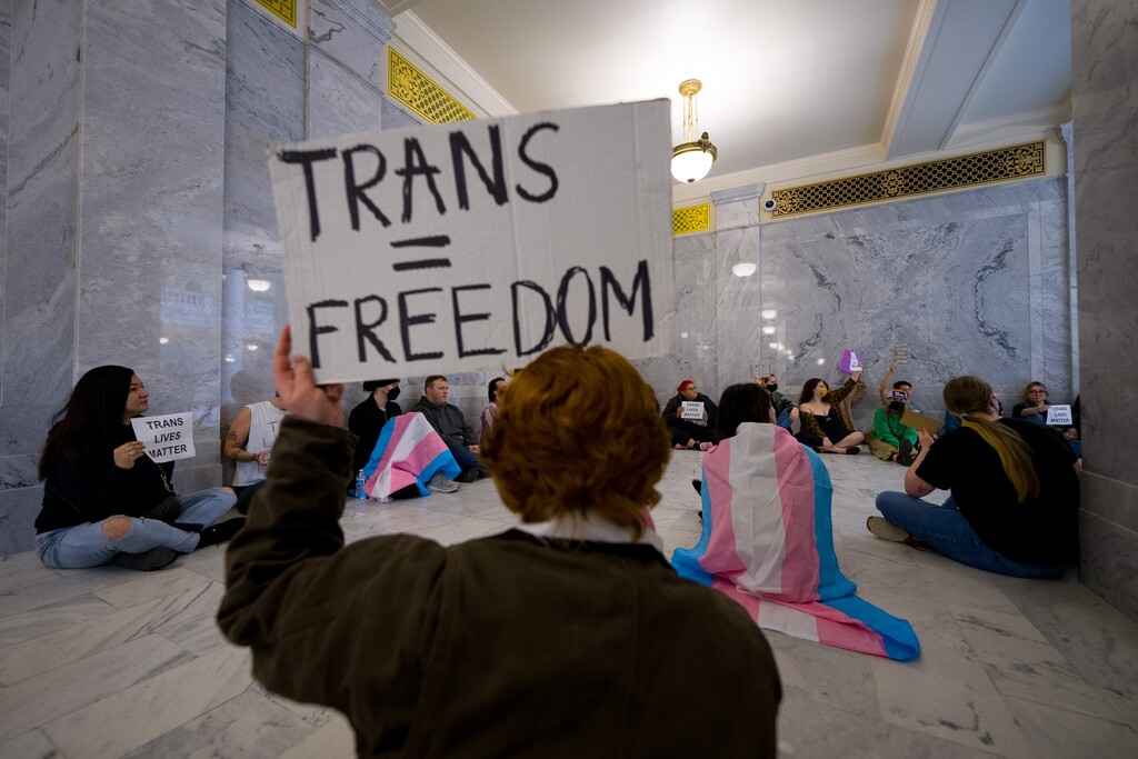 (Trent Nelson | The Salt Lake Tribune) Activists in support of transgender rights hold a sit-in in front of a bathroom at the Utah Capitol in Salt Lake City on Thursday, Feb. 22, 2024.