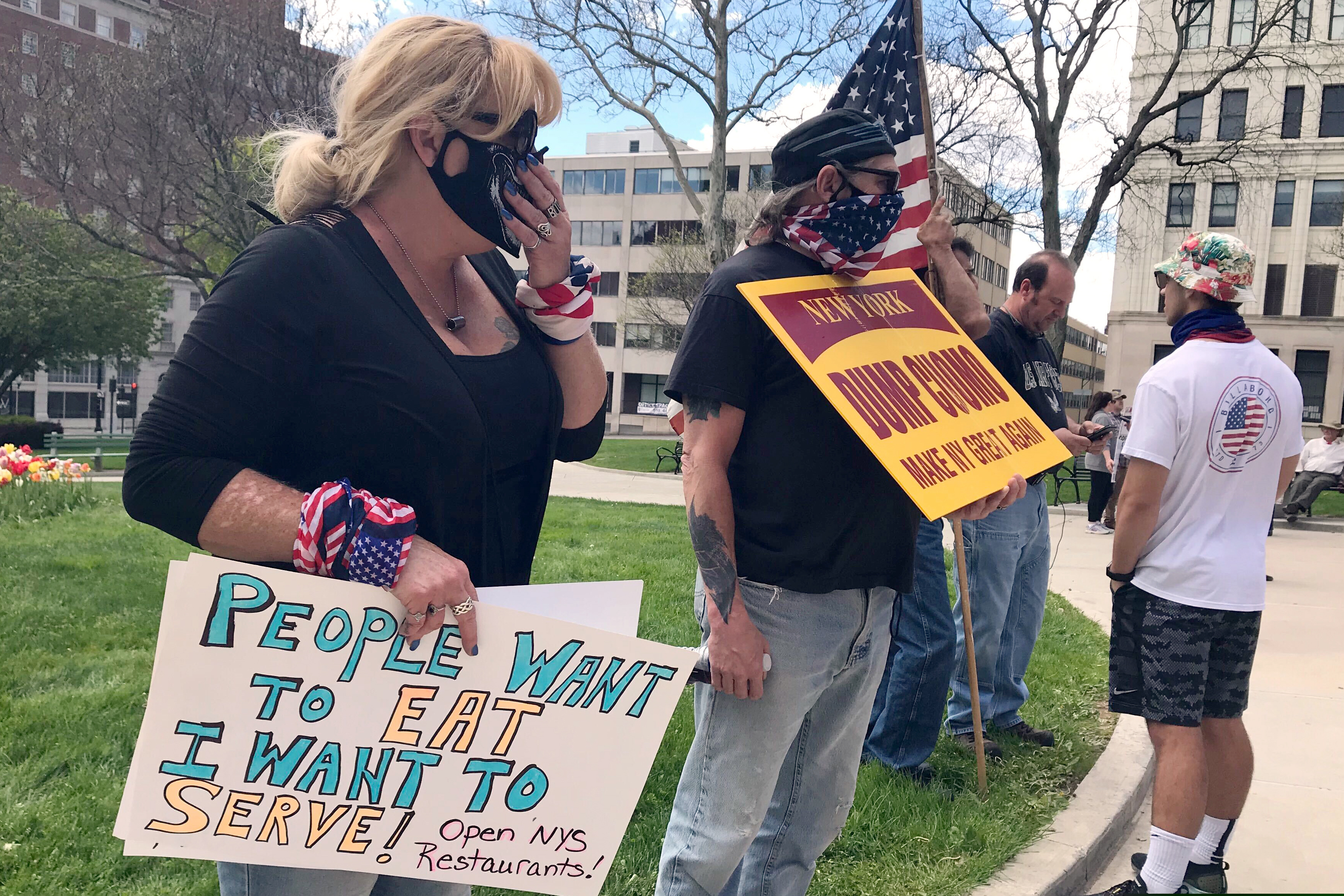 Protesters gather near the State Capitol in Albany, N.Y., calling for the state to reopen the economy, Saturday, May 16, 2020. During New York Gov. Andrew Cuomo's news conference on Saturday, he mention some additional loosening up of COVID-19 related restrictions but cautioned that the state could see a rise in cases as the economy opens up. To avoid another spike, people will still need to take precautions like social distancing, he said. (AP Photo/Marina Villeneuve)