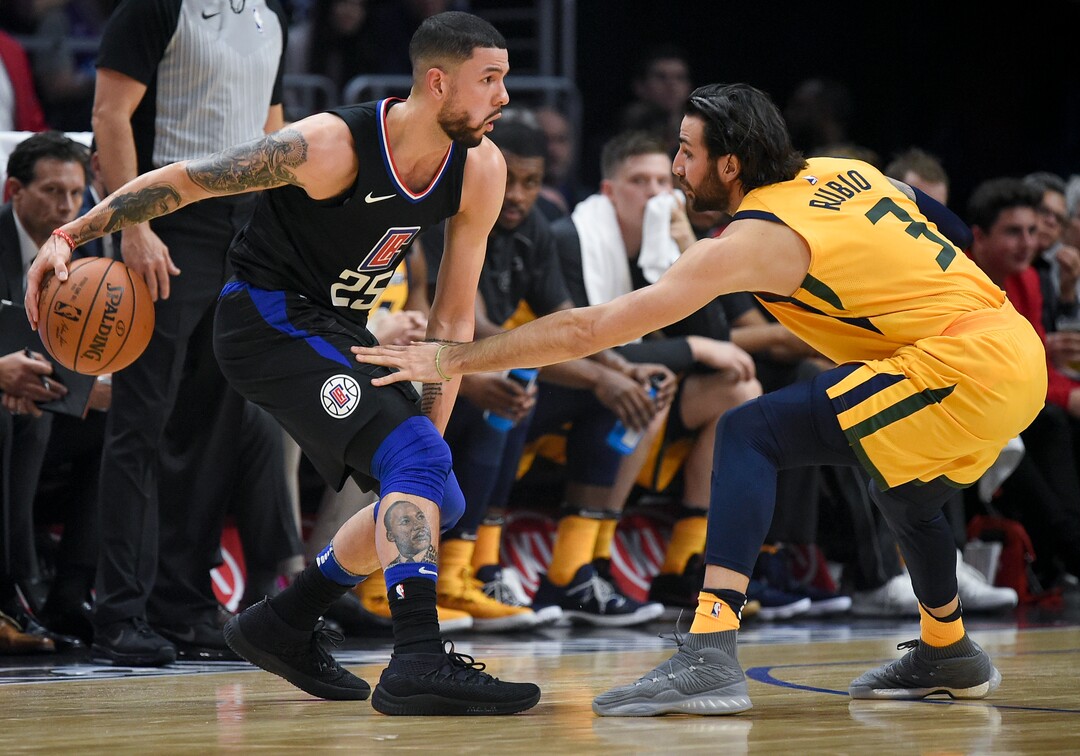 Los Angeles Clippers guard Austin Rivers, left, handles the ball as Utah Jazz guard Ricky Rubio defends during the first half of an NBA basketball game in Los Angeles, Thursday, Nov. 30, 2017. (AP Photo/Kelvin Kuo)