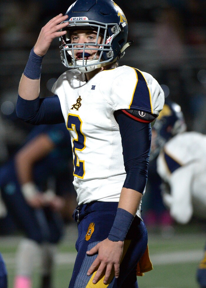 (Leah Hogsten | The Salt Lake Tribune) Summit Academy's quarterback Hayden Reynolds checks a play call. Summit Academy boys' football team leads Juan Diego High School 51-43 during their game, October 13, 2017 in Draper.