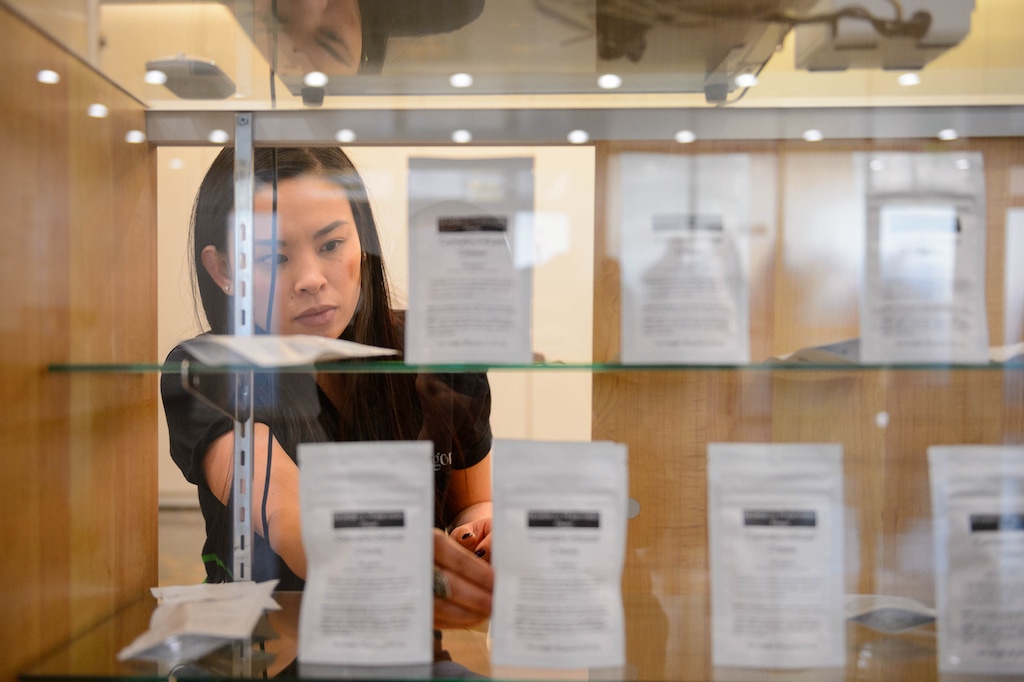 (Trent Nelson  |  Tribune file photo) Lien Nguyen stocks the shelves as Dragonfly Wellness becomes the first of Utah's 14 medical cannabis pharmacies to open for business in Salt Lake City, March 2, 2020.