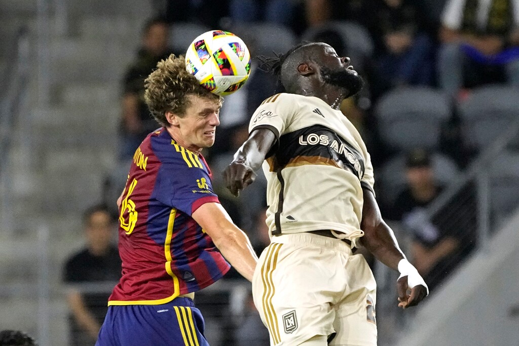 (Mark J. Terrill | AP) Real Salt Lake defender Philip Quinton, left, heads the ball as Los Angeles FC forward Kei Kamara misses during the second half of an MLS soccer match Wednesday, July 17, 2024, in Los Angeles.