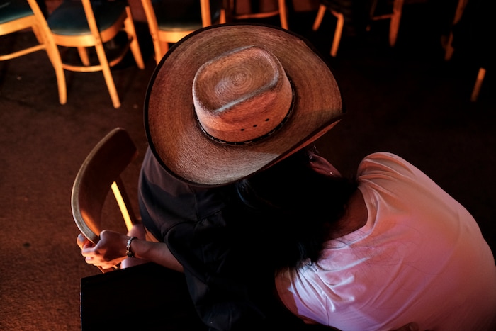 (Adriana Zehbrauskas | The New York Times) A couple attend a concert by Stateline, a Navajo country band, in Gallup, N.M., Nov. 6, 2019. At highway honky-tonks, casino lounges and far-flung dance halls, a form of music that many associate with rural white America is flourishing in the heart of Indian country, and no tribe have put their own stamp on country music quite like the Navajo.