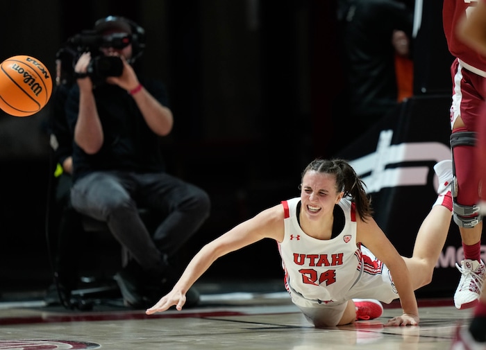 (Francisco Kjolseth | The Salt Lake Tribune) Utah Utes guard Kennady McQueen (24) gets tripped up as the University of Utah hosts the Oklahoma Sooners in women’s NCAA basketball in Salt Lake City on Wednesday, Nov. 16, 2022.